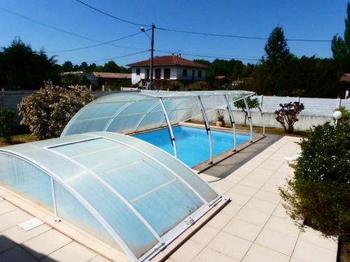 a swimming pool with a glass dome on a patio at Plaisirs de Lège in Lège-Cap-Ferret