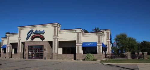 a store front of a restaurant on a street at AmericInn by Wyndham Sartell in Sartell