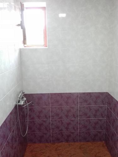 a bathroom with purple tiles and a window at Karine B&B in Yeghegnadzor