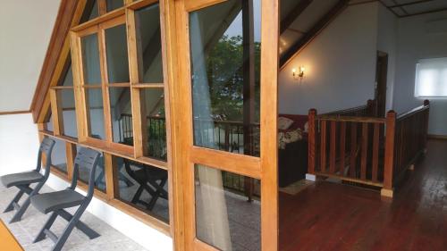 a room with sliding glass doors and a balcony at Skyline View in Bel Ombre