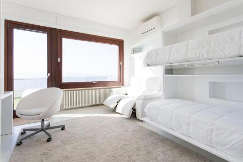 a bedroom with a bed and a desk and a chair at Reggio Suite in Reggio di Calabria