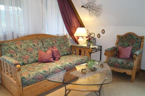 a living room with a couch and a glass table at Haus Schneider in Gutach