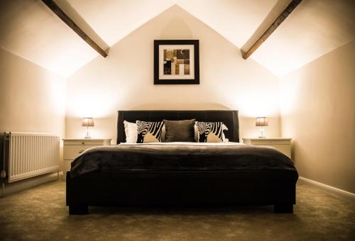 a bedroom with a large bed with two night stands at The Old Granary in York
