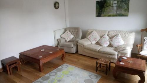 a living room with a couch and a coffee table at The Old Swan in Cold Ashton