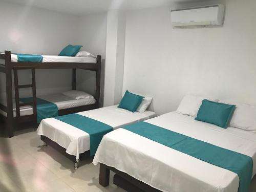 a room with two bunk beds and a ladder at Mayva AprtaHotel in Santa Marta