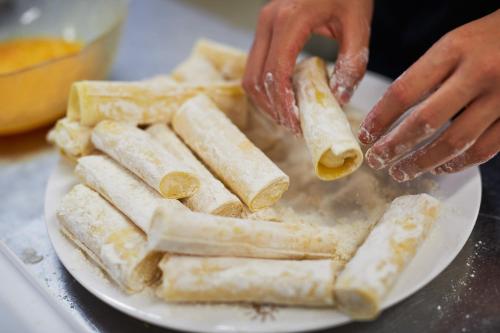 a person is preparing food on a plate at Jesolopalace Hotel & Aparthotel in Lido di Jesolo