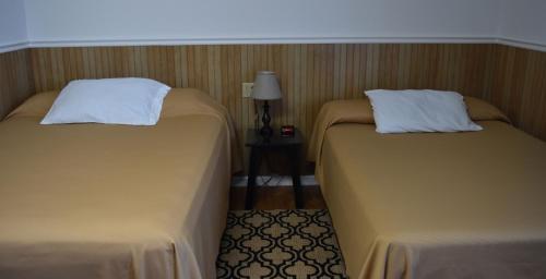 two beds sitting next to each other in a room at Gorgeous View Motel in Watkins Glen