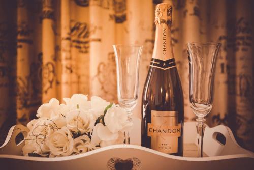 a bottle of champagne and two champagne glasses on a table at Belle Le Vie in Sassafras
