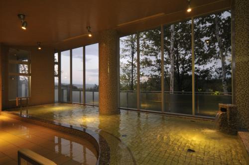 a large building with a view of the water at Shin Furano Prince Hotel in Furano