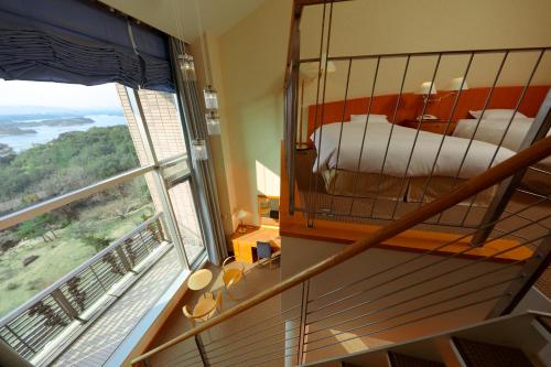 a bedroom with a bunk bed and a large window at Miyako Resort Okushima Aqua Forest in Shima