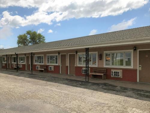 a building with benches in front of it at Budget Inn in Sedalia