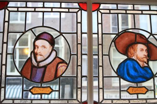 a stained glass window with two men on it at Bed & Breakfast The 9 Streets in Amsterdam
