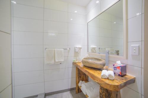 a bathroom with a sink and a mirror at Saletoga Sands Resort & Spa in Matatufu