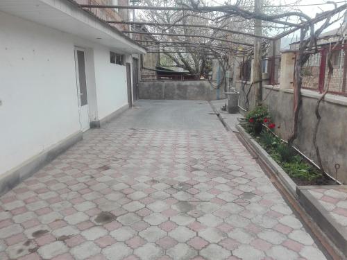 an empty courtyard of a building with a walkway at Karine B&B in Yeghegnadzor