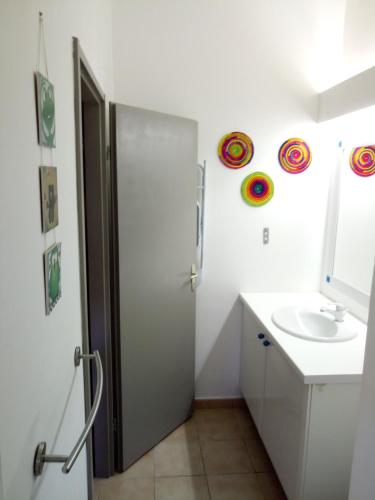 a bathroom with a shower and a sink and a mirror at A Ka Foufou La in Bouillante