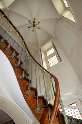 a spiral staircase in a house with a ceiling at Chateau de la Rozelle in Cellettes