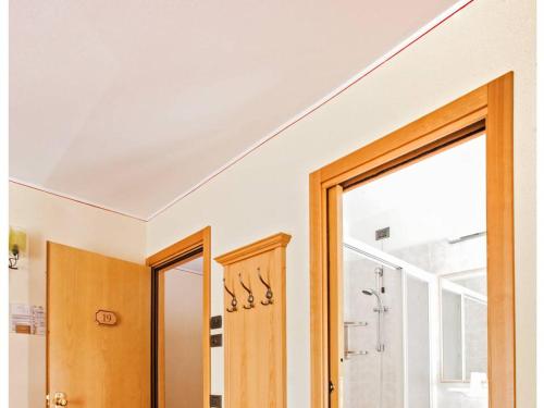 a room with a door and a window and a bathroom at Hotel Ristorante Miramonti in Val Masino