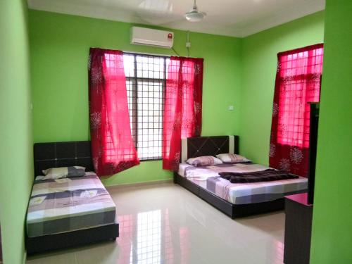 En eller flere senge i et værelse på HR Iman Homestay