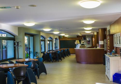 a restaurant with tables and chairs and a bar at Hotel Brasilia in Lido di Classe