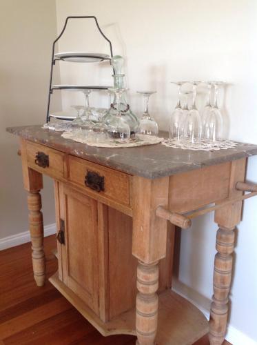 a table with wine glasses on top of it at The Avenue at Montville Cottage in Montville