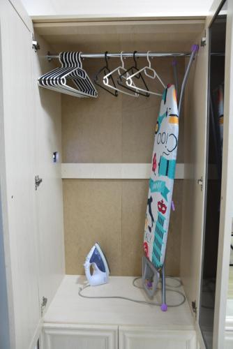 a closet with a surfboard and hangers at Old Tbilisi Narikala Apartment in Tbilisi City