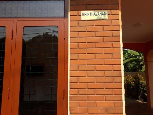 a brick wall with a street sign on it at Brinthavanam Days Inn in Jaffna