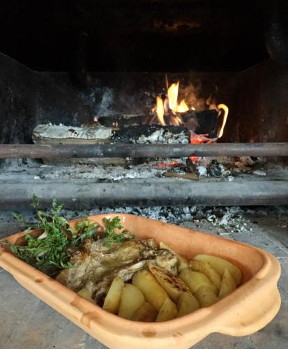 a bowl of food in front of a fire at B&B OPG Culig in Ozalj
