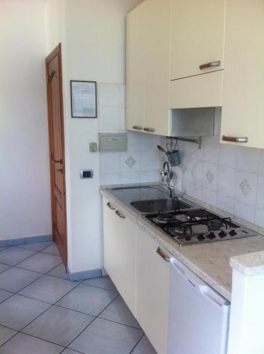 a kitchen with a sink and a stove at Excelsior Mare Suite in Ischia