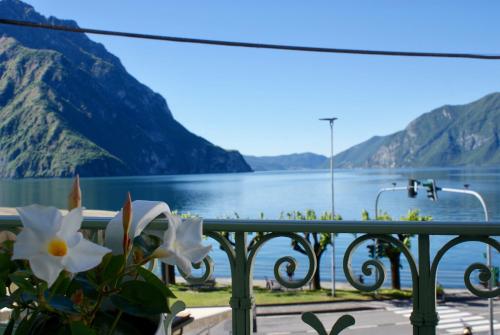 a view of a lake from a balcony with flowers at Albergo Diffuso Vulcano Village in Castro