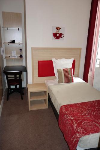 a hotel room with two beds and a desk at D'win in Paris