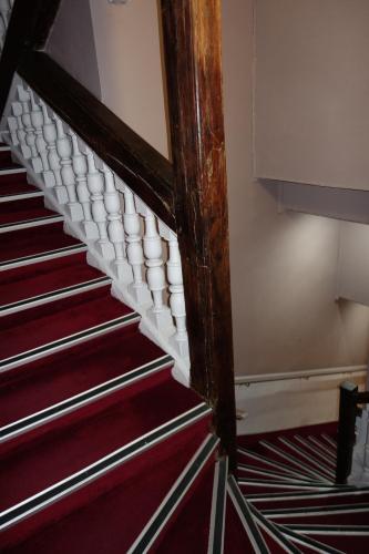 a staircase in a room with red carpet at D'win in Paris