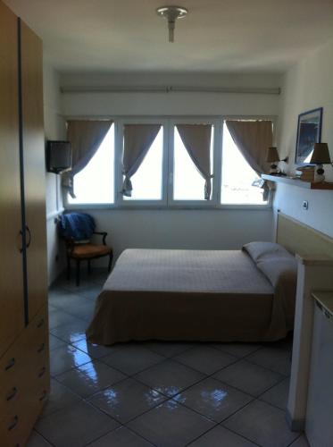 a bedroom with a bed and a window at Excelsior Mare Suite in Ischia