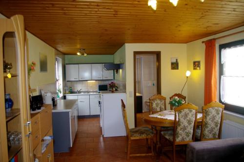 a kitchen with a table and chairs in a room at Ferienhaus und Ferienwohnung Büttner in Rathmannsdorf