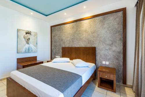 a bedroom with a bed and a large wall at Gaia Royal in Mastichari