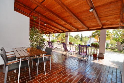 a patio with a wooden table and chairs at Apartments Katarina in Veli Rat