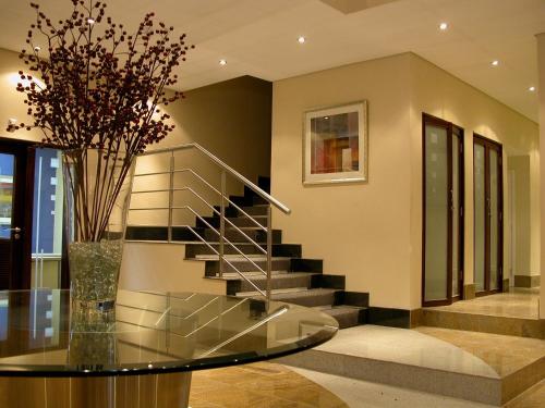 a staircase in a house with a glass table at Hotel 2001 in Maputo