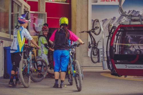 a group of people standing with bikes in a garage at Lai Lifestyle Hotel in Lenzerheide