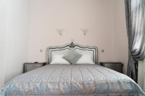 a bedroom with a large bed with two night stands at Le Bijou Luxury Rooms & Suites in Veria