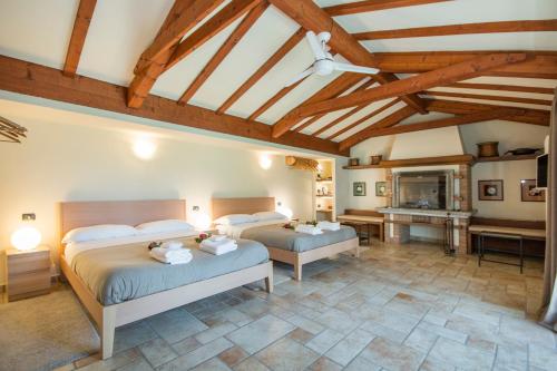 a bedroom with two beds and a fireplace at Casa Ceruti in Villa Guardia