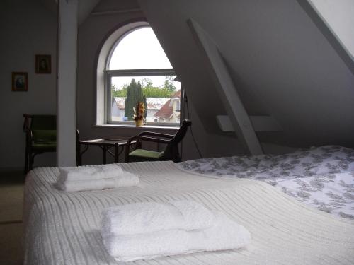 a bedroom with a bed with towels on it at Mikkelborg Kro in Rødding