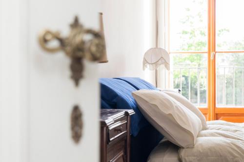 a bedroom with a bed and a window and a table at Villa Il Padule in Bagno a Ripoli