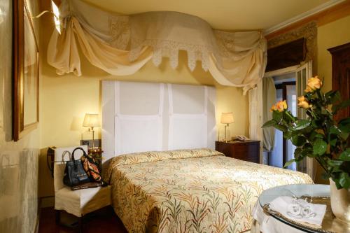 a bedroom with a bed with a large window at Hotel Gabbia D'Oro in Verona