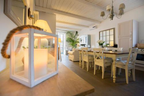a dining room and living room with a table and chairs at Azzurro B&B in Cefalù