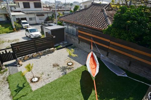 a garden with an umbrella in a yard with a car at South Island in Itoman