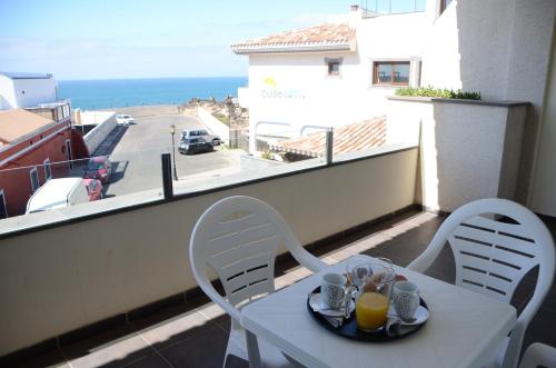 a table and chairs on a balcony with a view of a street at Cotillo Ocean View in Cotillo