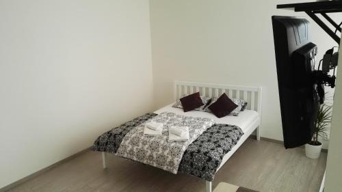 a bedroom with a bed with pillows on it at Alfa Panorama Brno in Brno