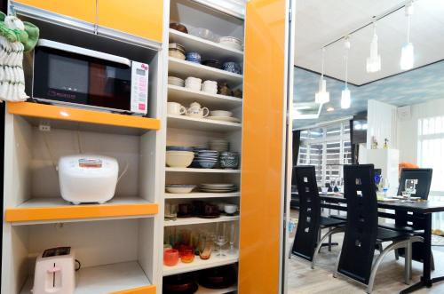 a kitchen with an open pantry with a table at South Island in Itoman
