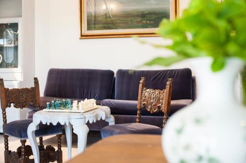 a living room with a couch and a table and chairs at Country Lodge B&B in Siena