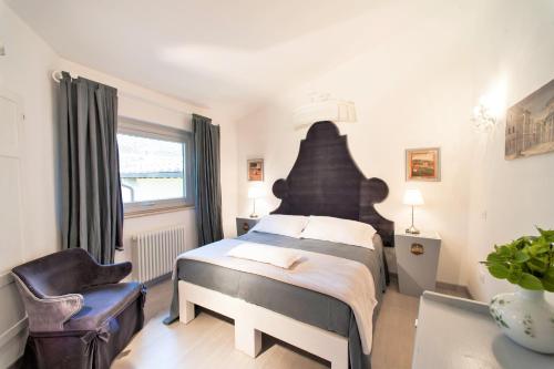 a bedroom with a large bed and a chair at Country Lodge B&B in Siena