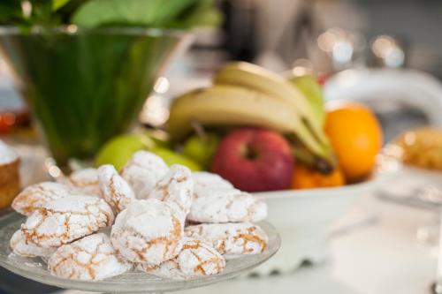 a plate of donuts on a table with fruit at Country Lodge B&B in Siena